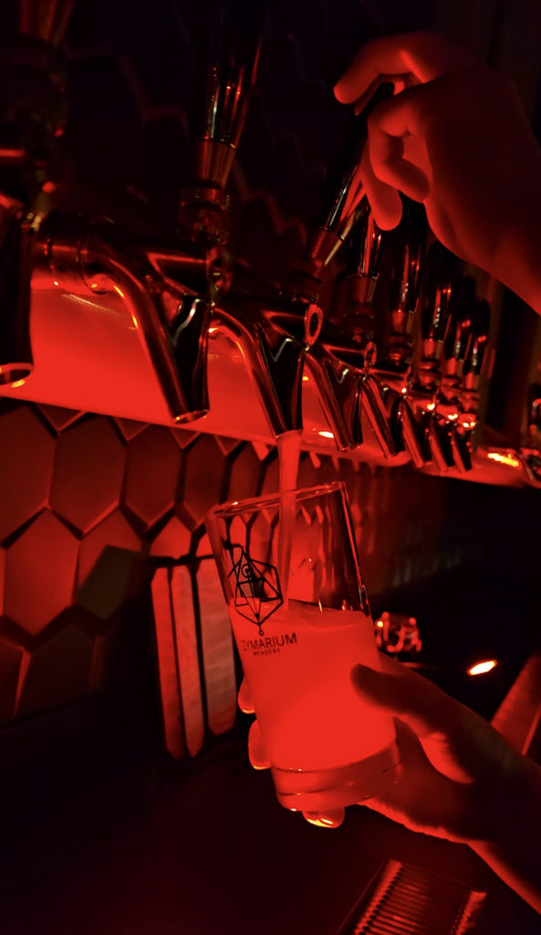 Zymarium Halloween - dark red image of taps pouring mead. 
